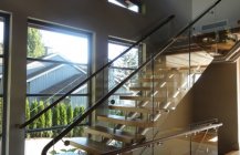 Фотография современной лестницы с прозрачными перилами.